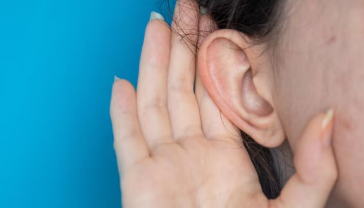 woman holding ear